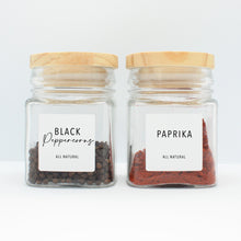 Load image into Gallery viewer, There are 2 spice bottles consisting of spices with their corresponding Macannlife Designs minimalist labels in Airy Thin Design. The first one is Black Peppercorns and the other one is Paprika.