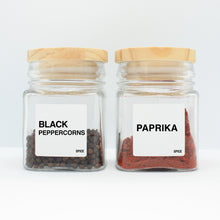 Load image into Gallery viewer, There are 2 spice bottles consisting of spices with their corresponding Macannlife Designs minimalist labels in Bold Design. The first one is Black Peppercorns and the other one is Paprika.