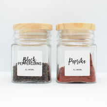 Load image into Gallery viewer, There are 2 spice bottles consisting of spices with their corresponding Macannlife Designs minimalist labels in Calligraphy Design. The first one is Black Peppercorns and the other one is Paprika.