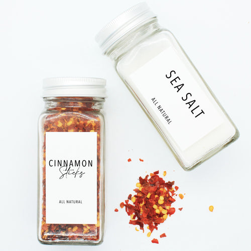 There are 2 spice bottles consisting of spices with their corresponding Macannlife Designs minimalist labels in Airy Thin Design. The first one is Chili Flakes and the other one is Salt.