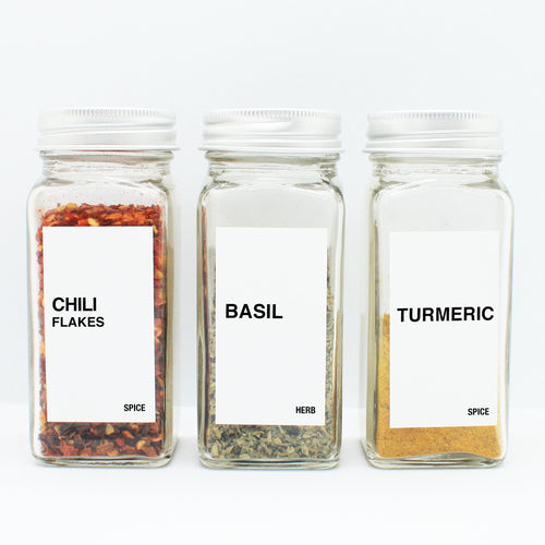 There are 3 spice bottles consisting of spices with their corresponding Macannlife Designs minimalist labels in Bold Design. The first one is Chili Flakes. The second one is Basil and the third one is Turmeric. The size for these labels are 1.25 x 2.25 Tall.