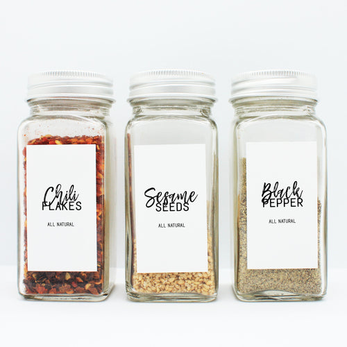 There are 3 spice bottles consisting of spices with their corresponding Macannlife Designs minimalist labels in Calligraphy Design. The first one is Chili Flakes. The second one is Sesame Seeds and the third one is Black Pepper. The size for these labels are 1.25 x 2.25 Tall.